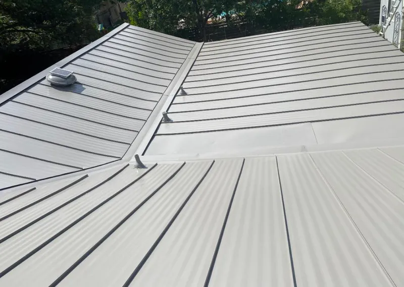 Solar attic fan installed on a metal roof for Roof Ventilation in Elk City